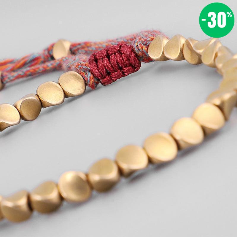 Bracelet bouddhiste en perles de cuivre et cordon coloré