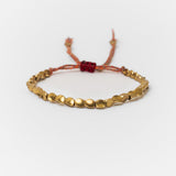 Bracelet bouddhiste en perles de cuivre et cordon coloré