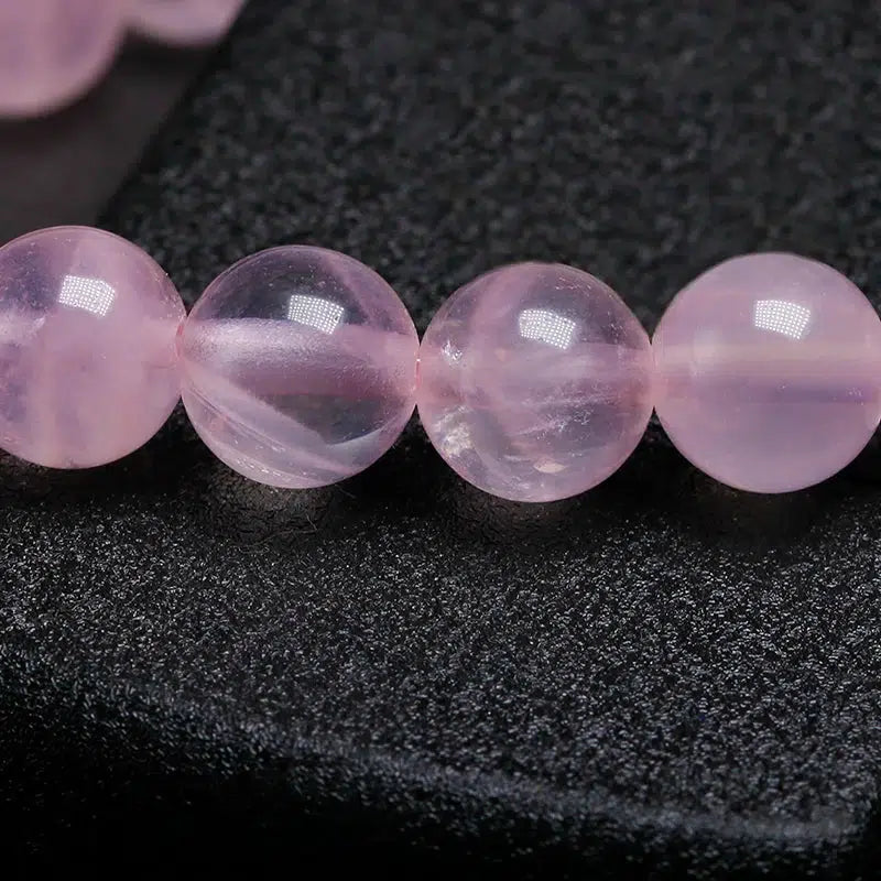 Bracelet en Quartz rose et perle centrale mantra « Om »